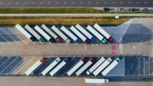 Overhead shot of semi-trucks parked in Poznań, Poland, demonstrating transportation logistics.